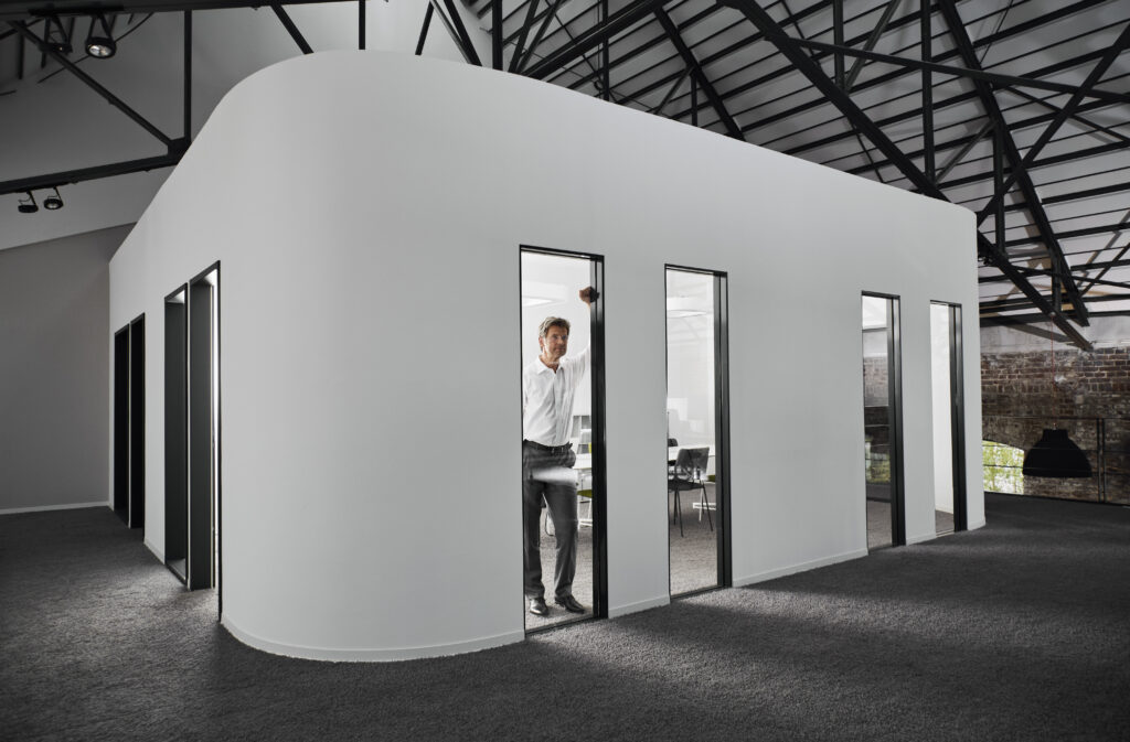 A modular trade show booth with customizable panels, LED lighting, and branded graphics, designed for a professional event setup.
