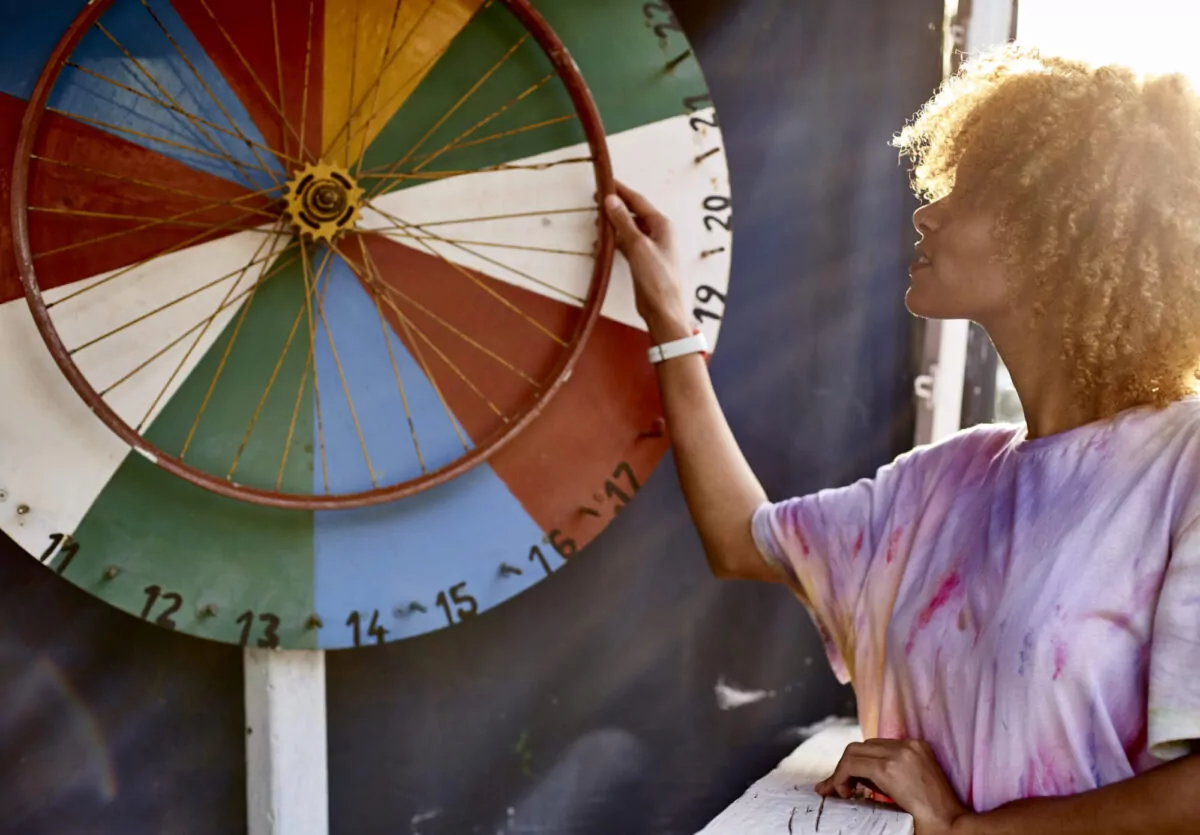 Woman spinning a colorful prize wheel, representing a fun and engaging way to collect emails through prize wheel games