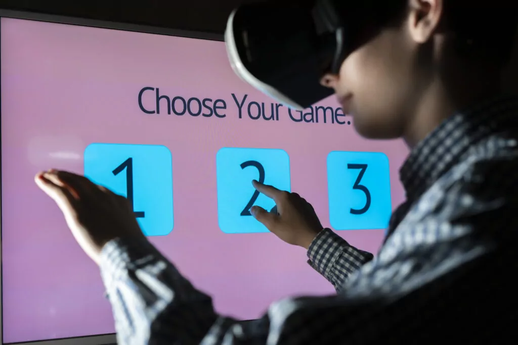 young man in vr glasses playing and choosing the game