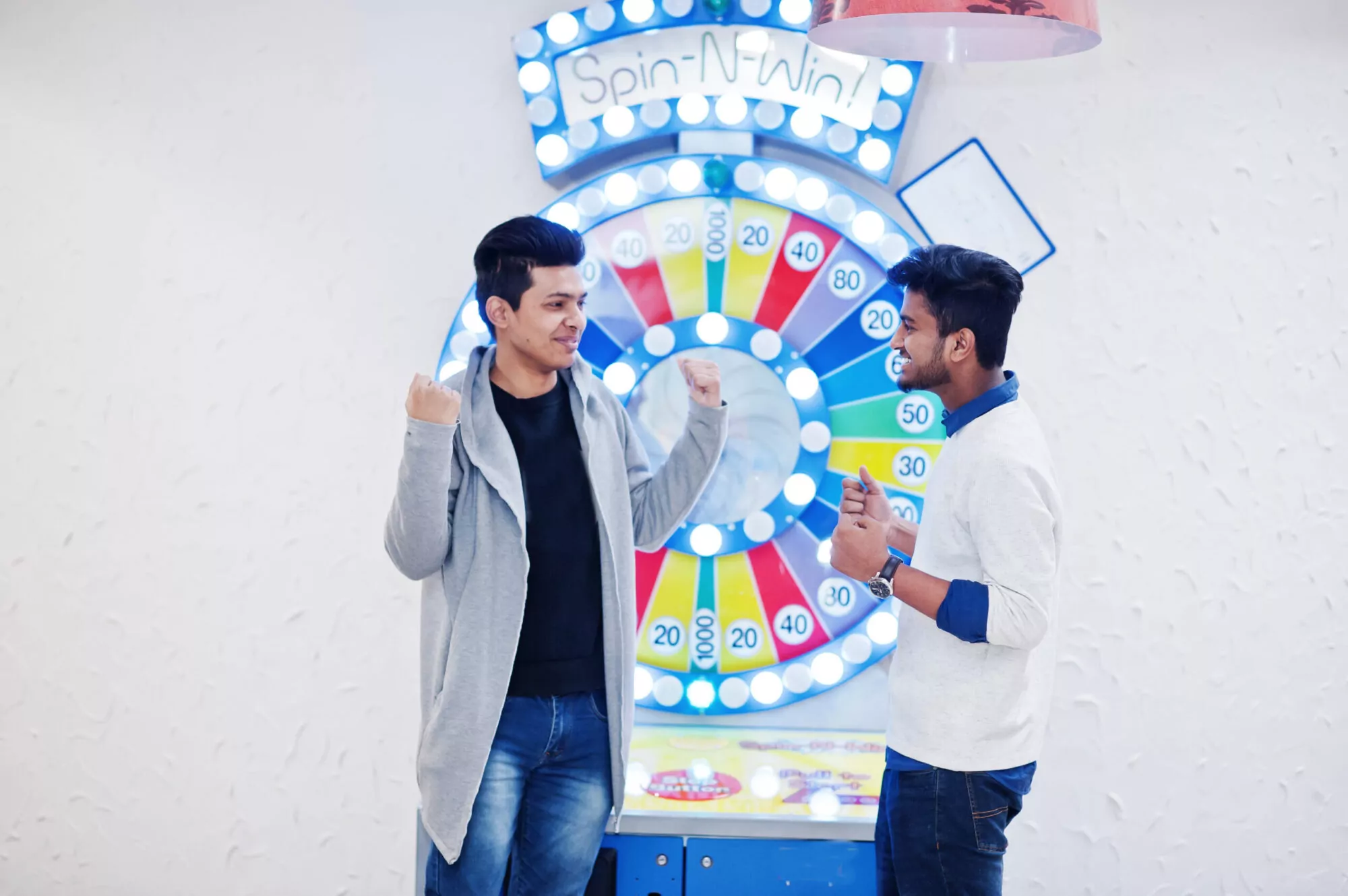 Participants excitedly interacting with a colorful spin-to-win wheel at an event, engaging with the prize mechanics.