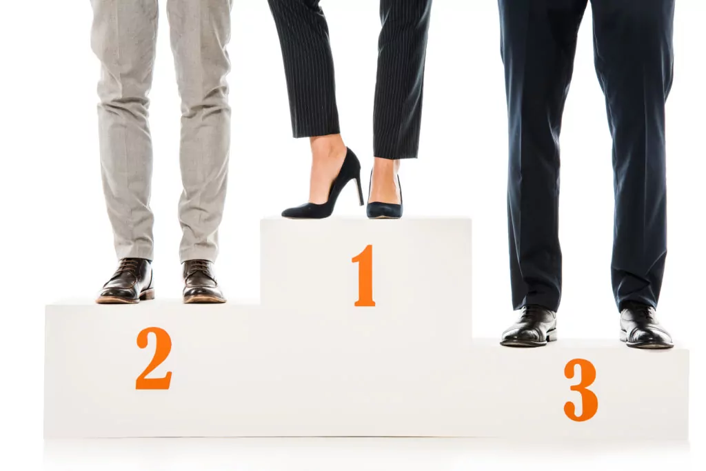 businesspeople standing on winners podium isolated on white
