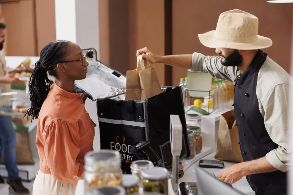 female courier takes items from cashier 2026 01 08 02 31 42 utc